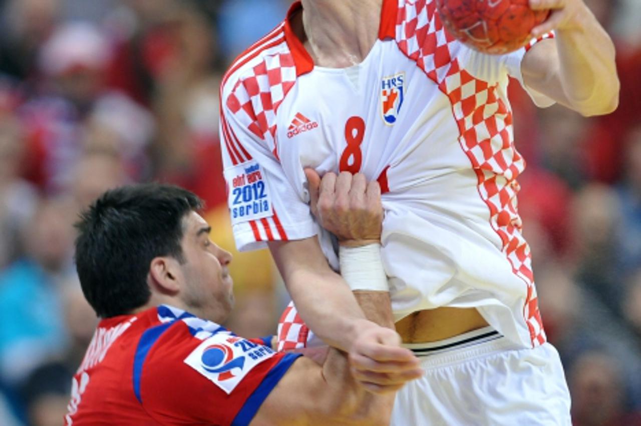 'Croatia\'s Marko Kopljar (R) vies with Serbia\'s Nenad Vuckovic during the men\'s EHF Euro 2012 Handball Championship semifinal match Serbia vs Croatia on January 27, 2012 at the Beogradska Arena in 