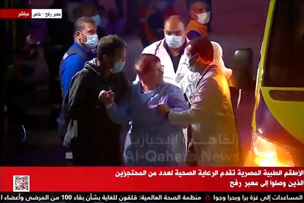 A convoy of vehicles carrying hostages abducted by Hamas militants during the October 7 attack on Israel arrives through the border crossing with Gaza