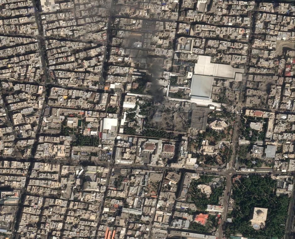 A satellite image shows black smoke rising and heavy damage at Iranian Supreme Leader Ayatollah Ali Khamenei's compound in Tehran