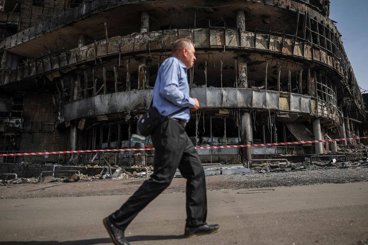 Residents wander around a site of a Russian attack in Kyiv