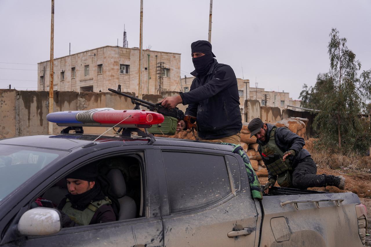 Syrian security forces outside al-Aqtan prison, where some Islamic State detainees are held, in Raqqa