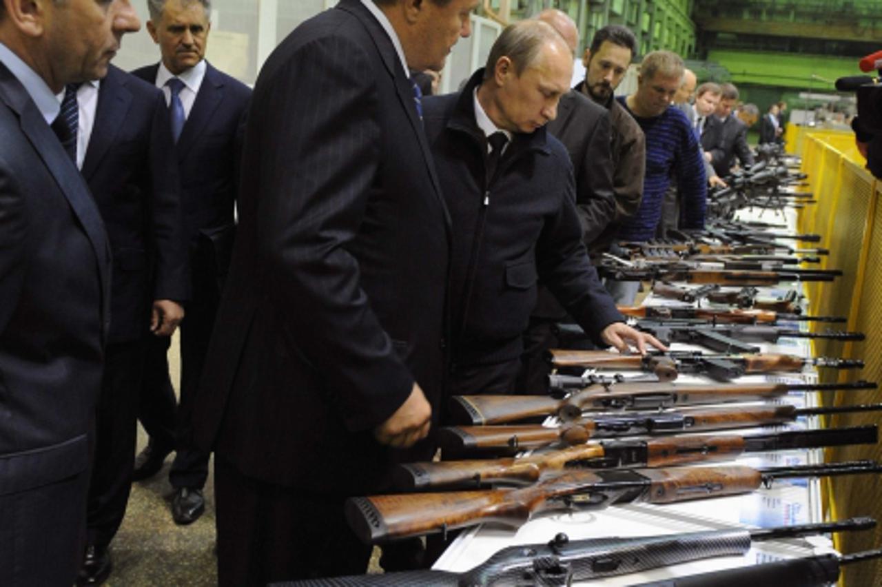 'REFILE - CORRECTING COMPANY NAME    Russia's President Vladimir Putin (C) inspects the exhibits as he visits Kalashnikov corporate group under Izhmash Open Joint Stock Company in Izhevsk, September 