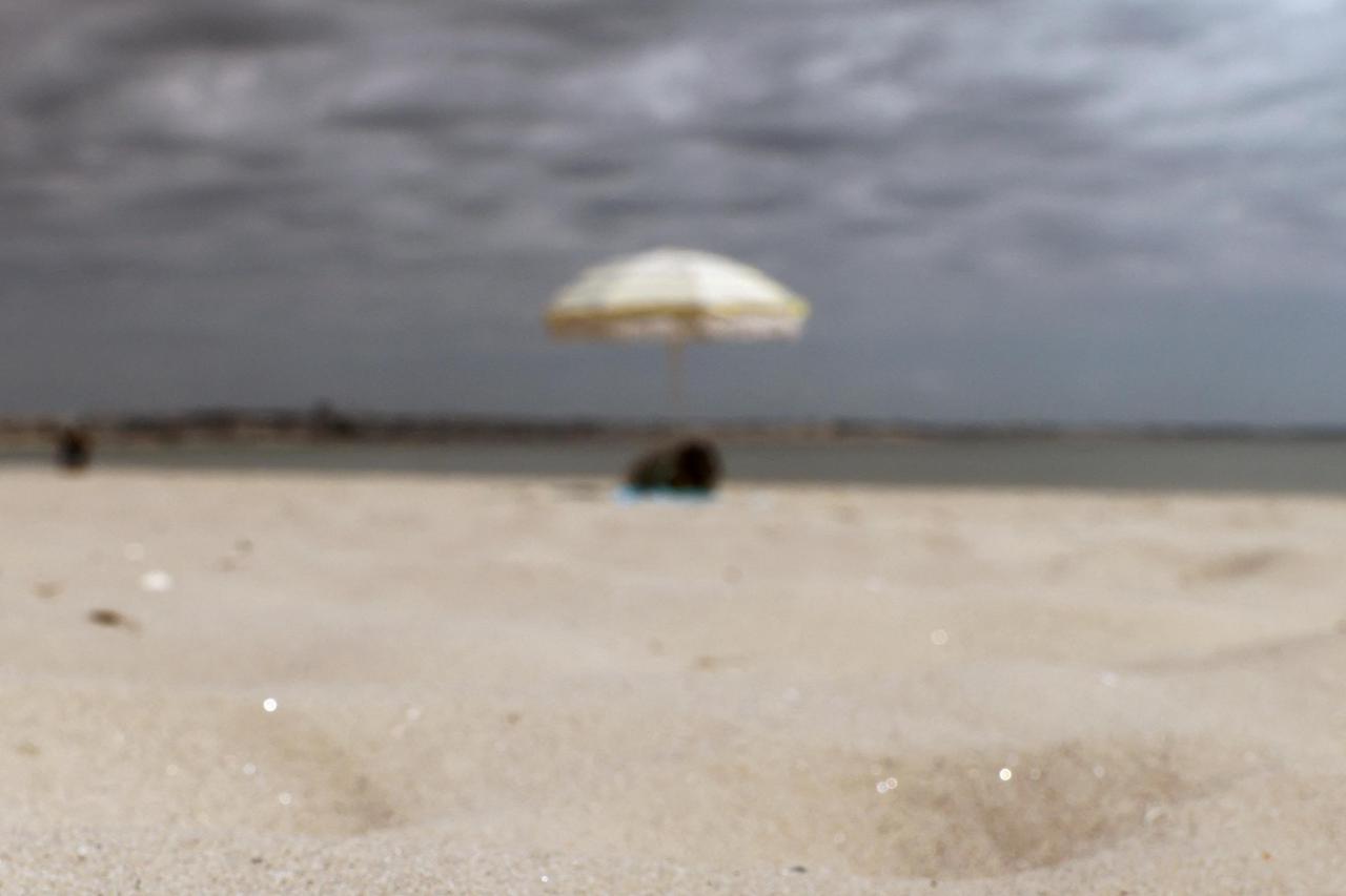 A discarded cigarette butt lies on the sand of La Baule beach on the Atlantic coast