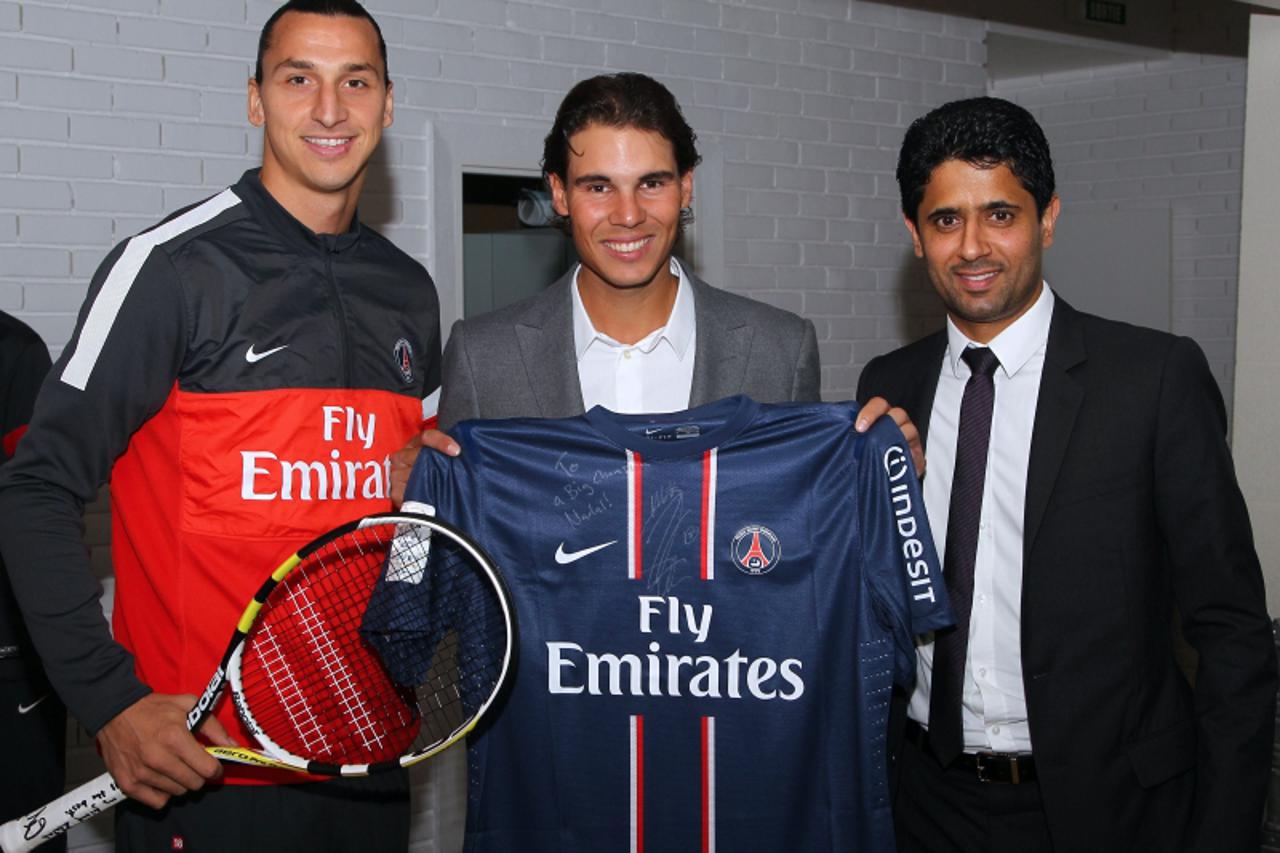 'Paris Saint-Germain\'s Swedish forward Zlatan Ibrahimovic (L)and Chairman of the Paris Saint-Germain L1 football club, Nasser Al-Khelaifi (R) of Qatar pose with Spain\'s tennis player Rafael Nadal at