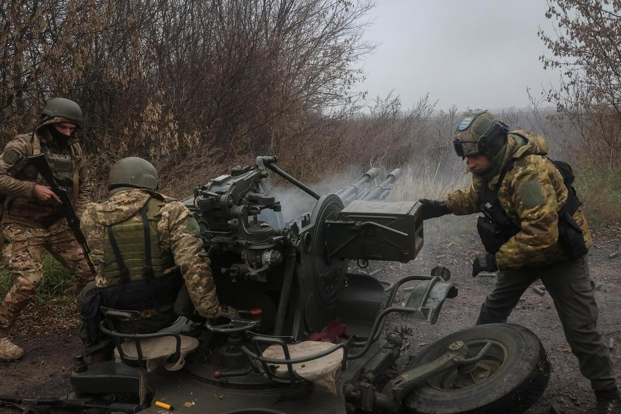 Ukrainian servicemen work with a ZU-23-2 anti-aircraft cannon at a position near a front line in the Kharkiv region