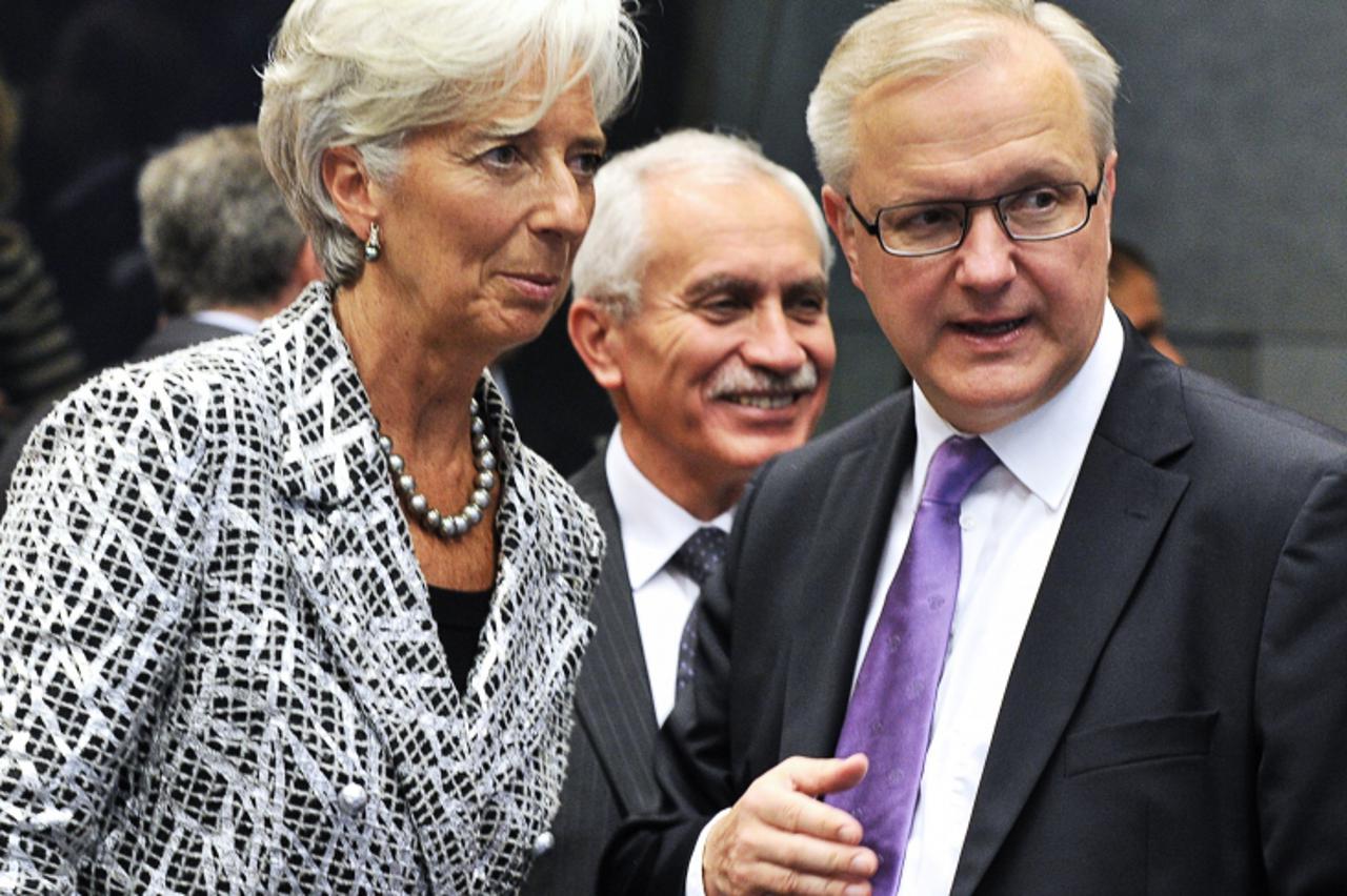 '(L-R) International Monetary Fund Managing Director Christine Lagarde listens to EU commissioner Economic and Monetary Affairs Olli Rehn before an Eurozone Council at the Kirchberg conference center 