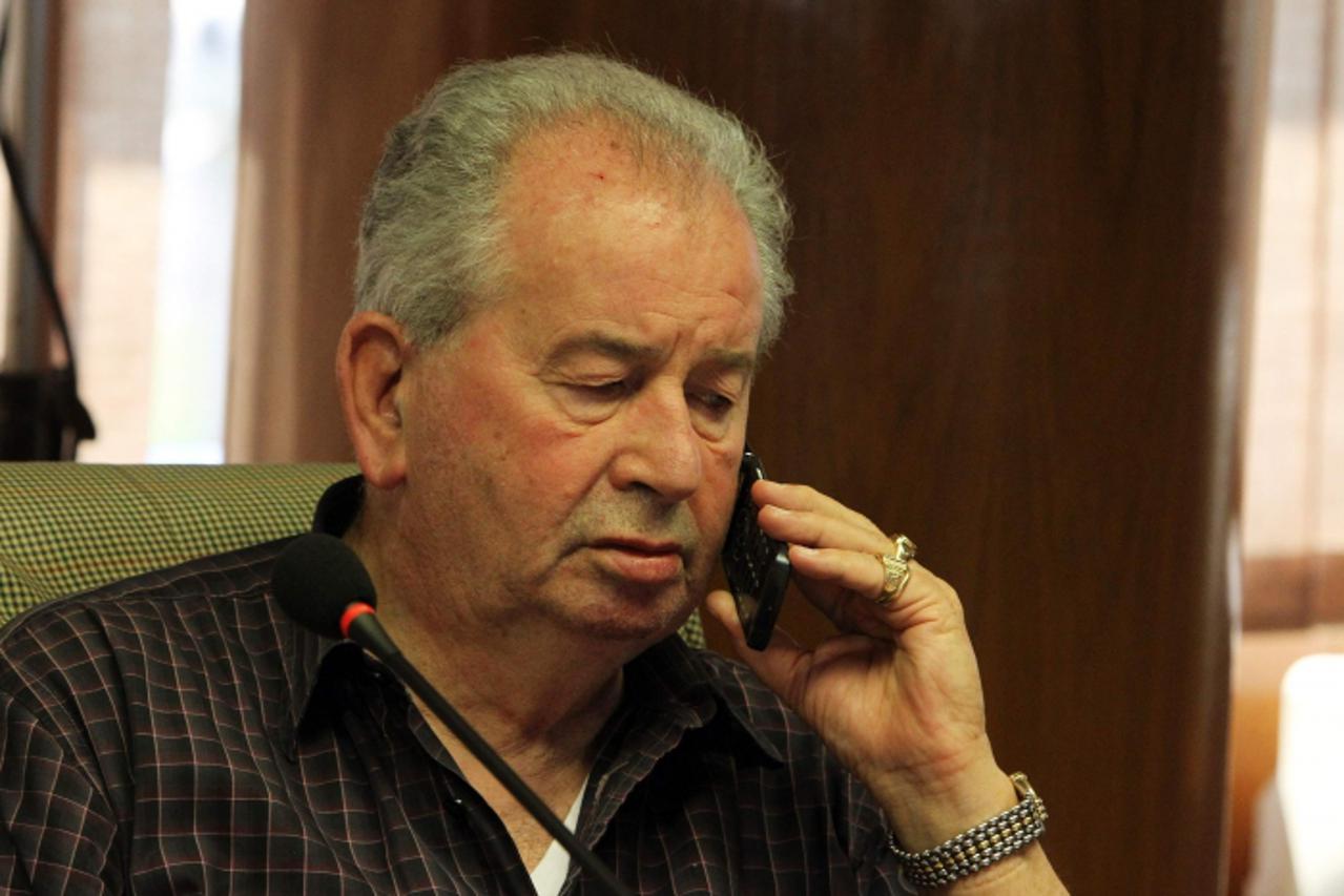 'President of the Argentine Football of Association Julio Grondona speaks on the phone during a meeting in Luque, March 17, 2011. The executive committee of the South American Soccer Confederation (CO