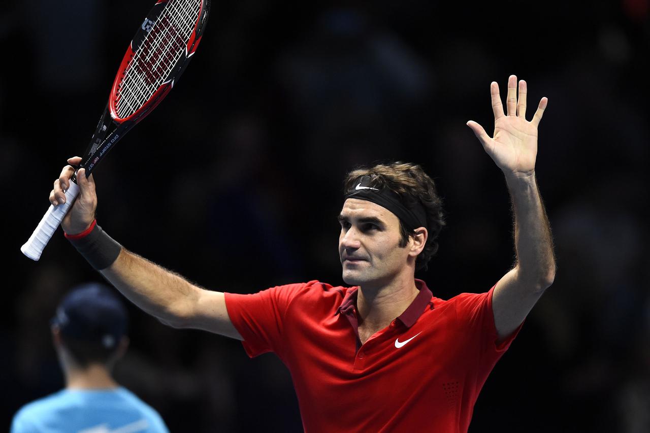 Roger Federer of Switzerland waves to the crowd after winning his men's singles tennis match against Milos Raonic of Canada at the ATP World Tour Finals at the O2 Arena in London November 9, 2014. Federer eased his way into the ATP World Tour Finals with 