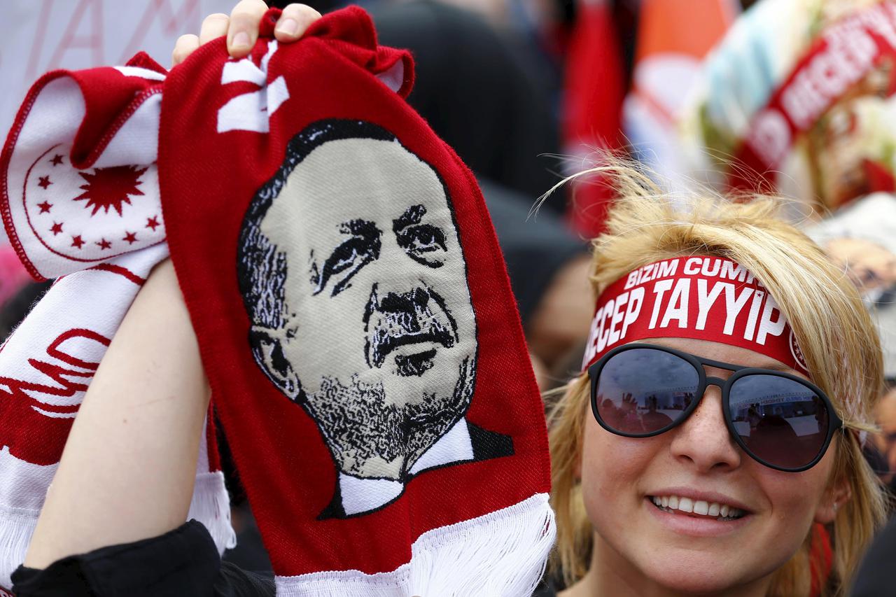 A supporter of Turkish President Tayyip Erdogan waves a scarf with an image of the president during a ceremony to mark the 562nd anniversary of the conquest of the city by Ottoman Turks, in Istanbul, Turkey, May 30, 2015. REUTERS/Murad Sezer