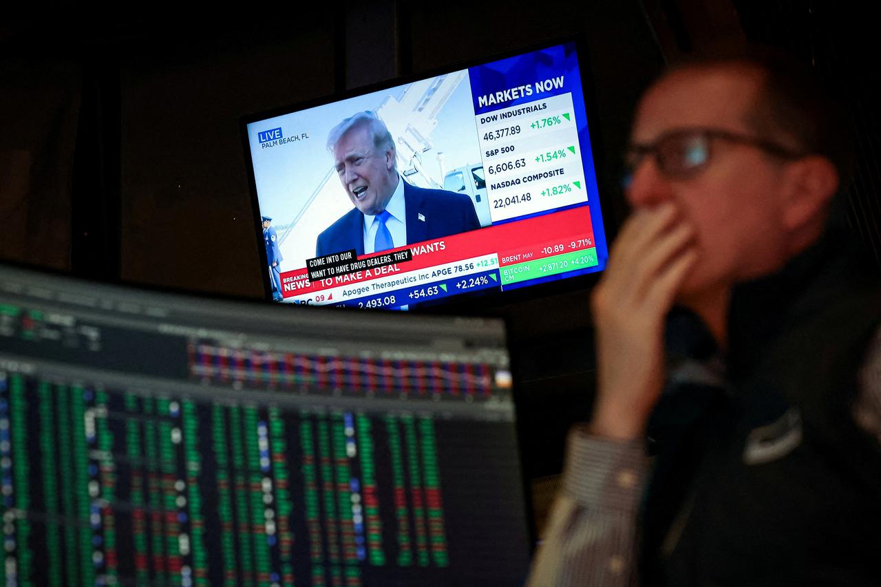 FILE PHOTO: Traders work on the floor of the NYSE in New York