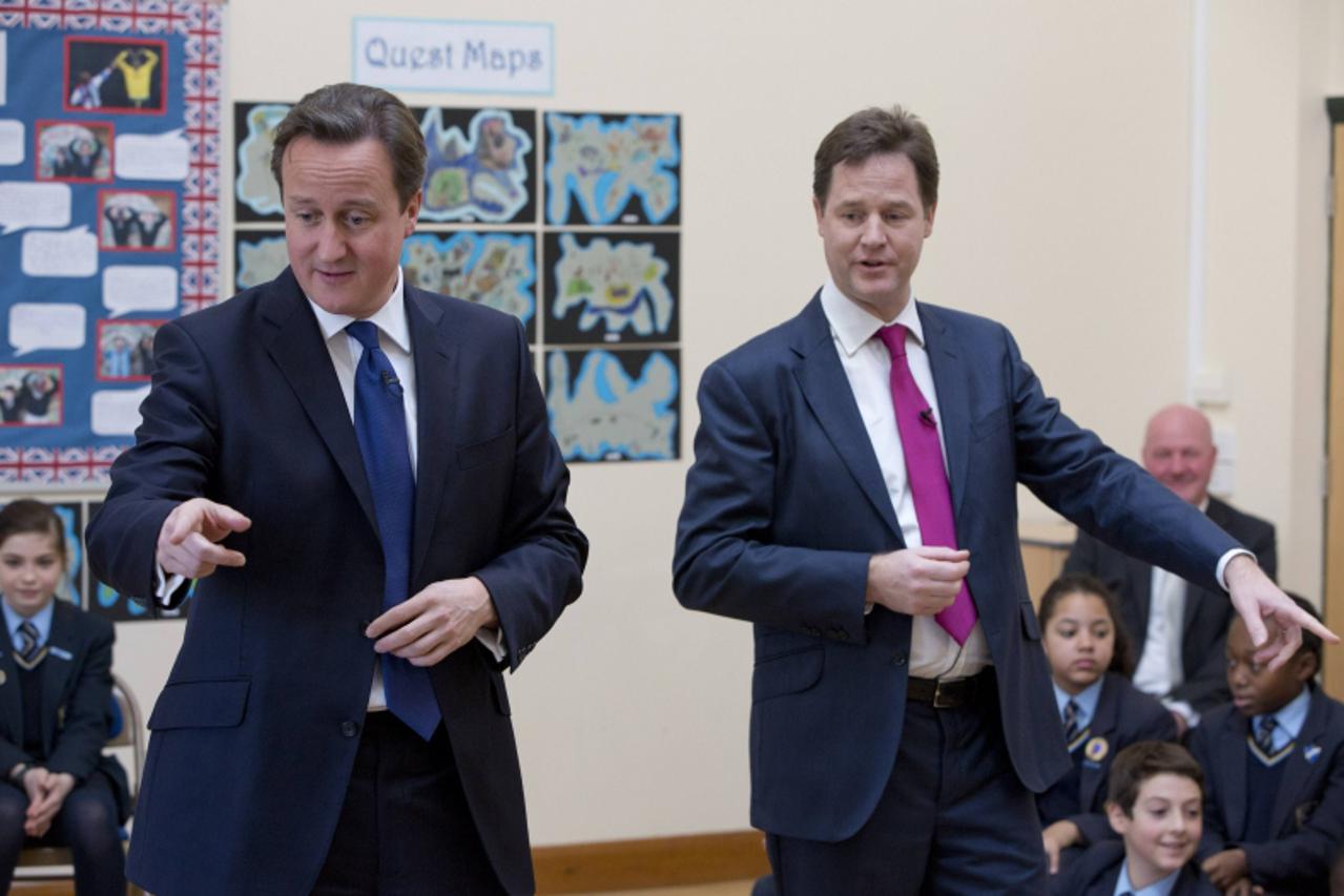 'Britain's Prime Minister David Cameron and Deputy Prime Minister Nick Clegg (R) meet children at Corpus Christi Roman Catholic Primary School in Brixton in London, December 4, 2012. REUTERS/Neil Hal