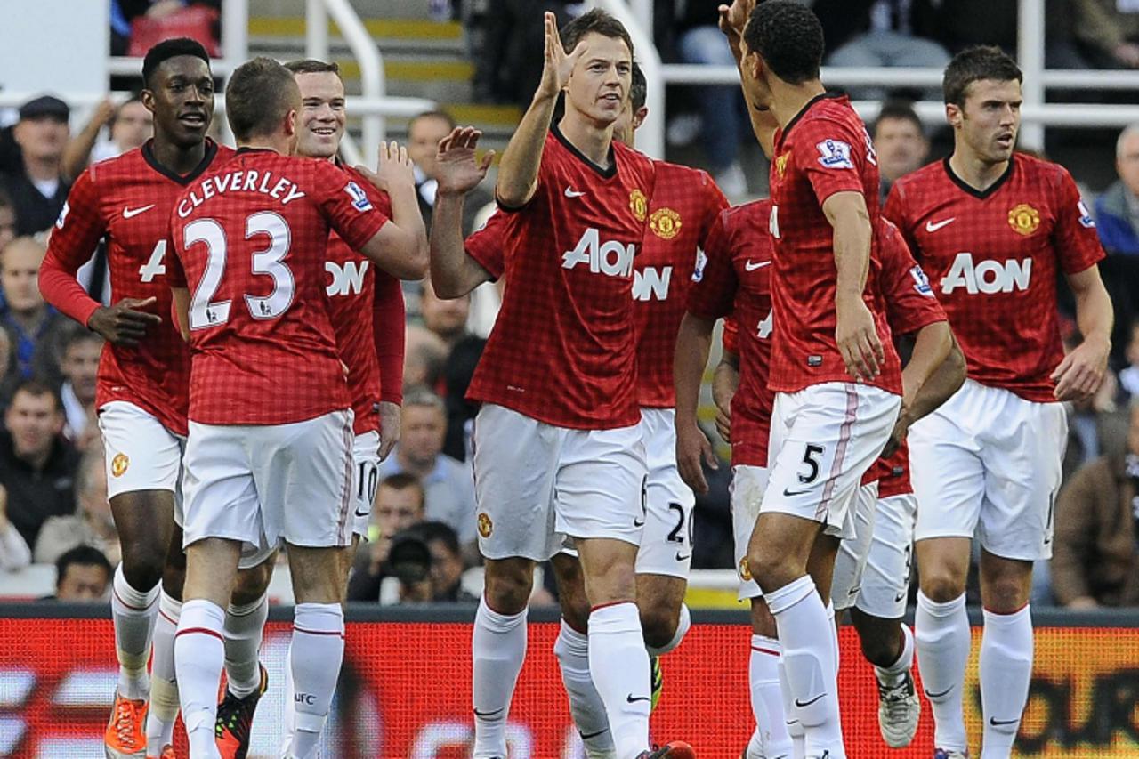 'Manchester United's Jonny Evans (C) celebrates scoring against Newcastle United with teammates during their English Premier League soccer match in Newcastle, northern England, October 7, 2012. REUTE