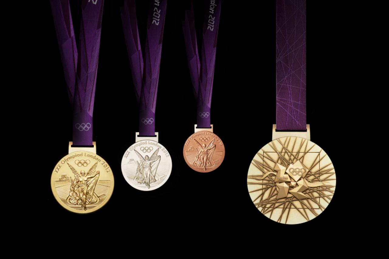 '(FILES) A handout image obtained from the London 2012 organising committee (LOCOG) on July 27, 2011 shows the London 2012 Olympic medals designed by British artist David Watkins. The Olympic medals? 