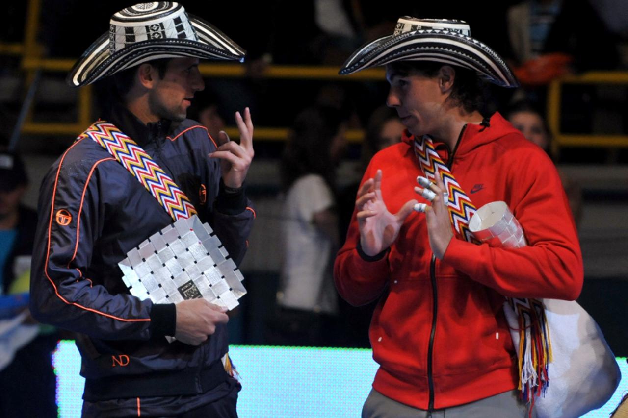 'Spanish tennis player Rafael Nadal (R) and Novak Djokovic of Serbia talk as they wear Colombian Vueltiao hats after an exhibition match that the players number one and two of the world play at El Cam