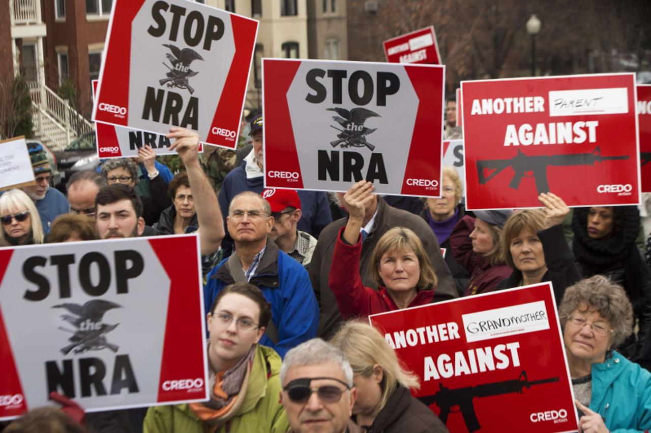 'Protesters marching with the social activist group CREDO along with other concerned citizens decend on the offices of the NRA's (National Rifle Association)Capitol Hill lobbiest's office demanding 