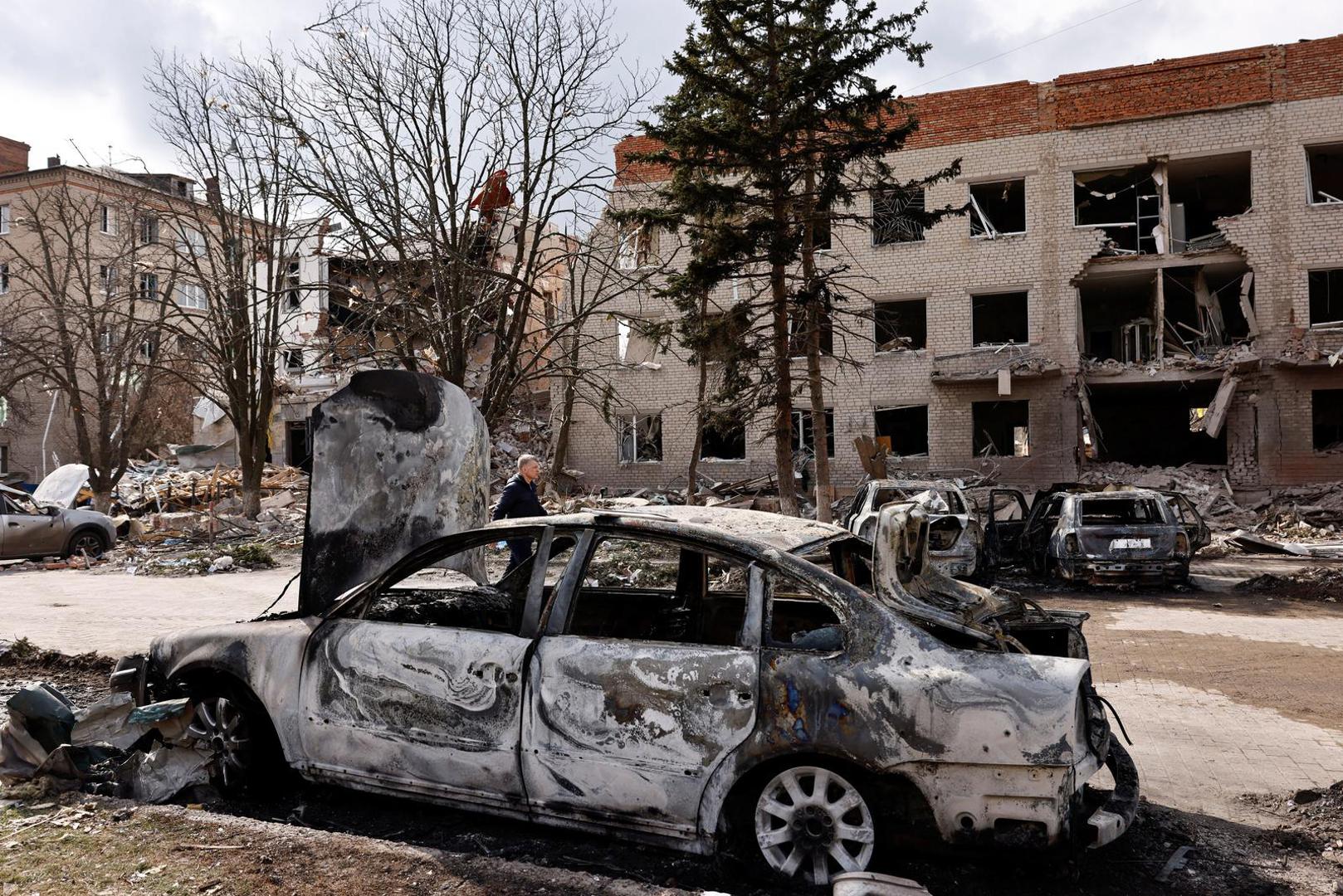 A person walks next to a damaged car in the aftermath of deadly shelling of an army office building, amid Russia's attack, in Sloviansk, Ukraine, March 27, 2023. REUTERS/Violeta Santos Moura Photo: VIOLETA SANTOS MOURA/REUTERS