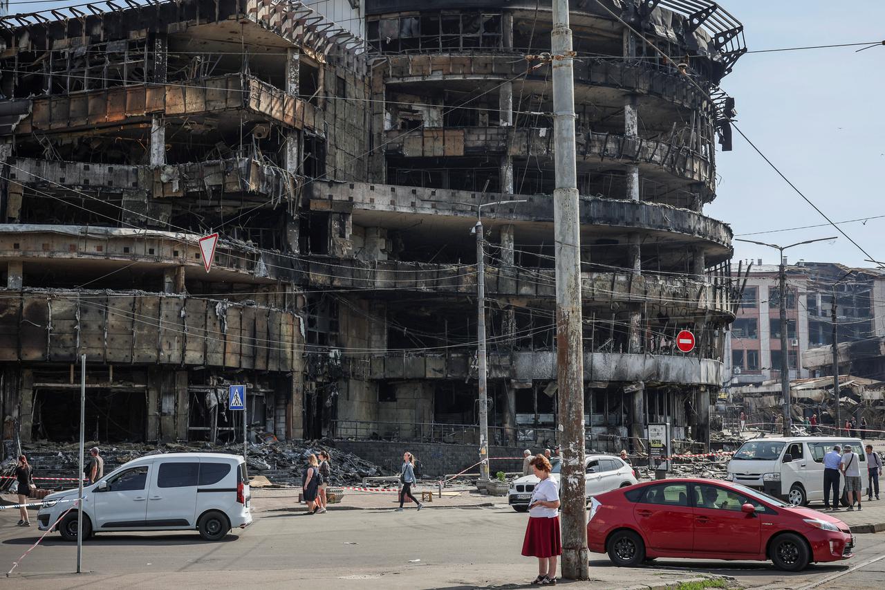 Residents wander around a site of a Russian attack in Kyiv
