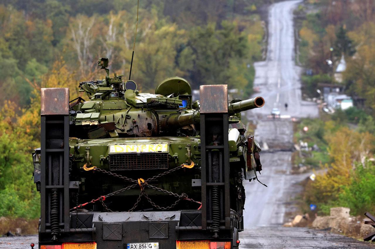 A truck carries a damaged tank, amid Russia's attack on Ukraine, in Donetsk region