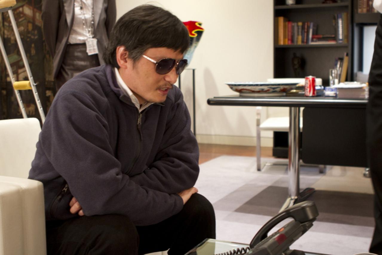 \'A handout photo from the U.S. Embassy Beijing Press office shows blind activist Chen Guangcheng (C) speaking into a phone in Beijing, May 2, 2012. Picture taken May 2, 2012. REUTERS/US Embassy Beiji