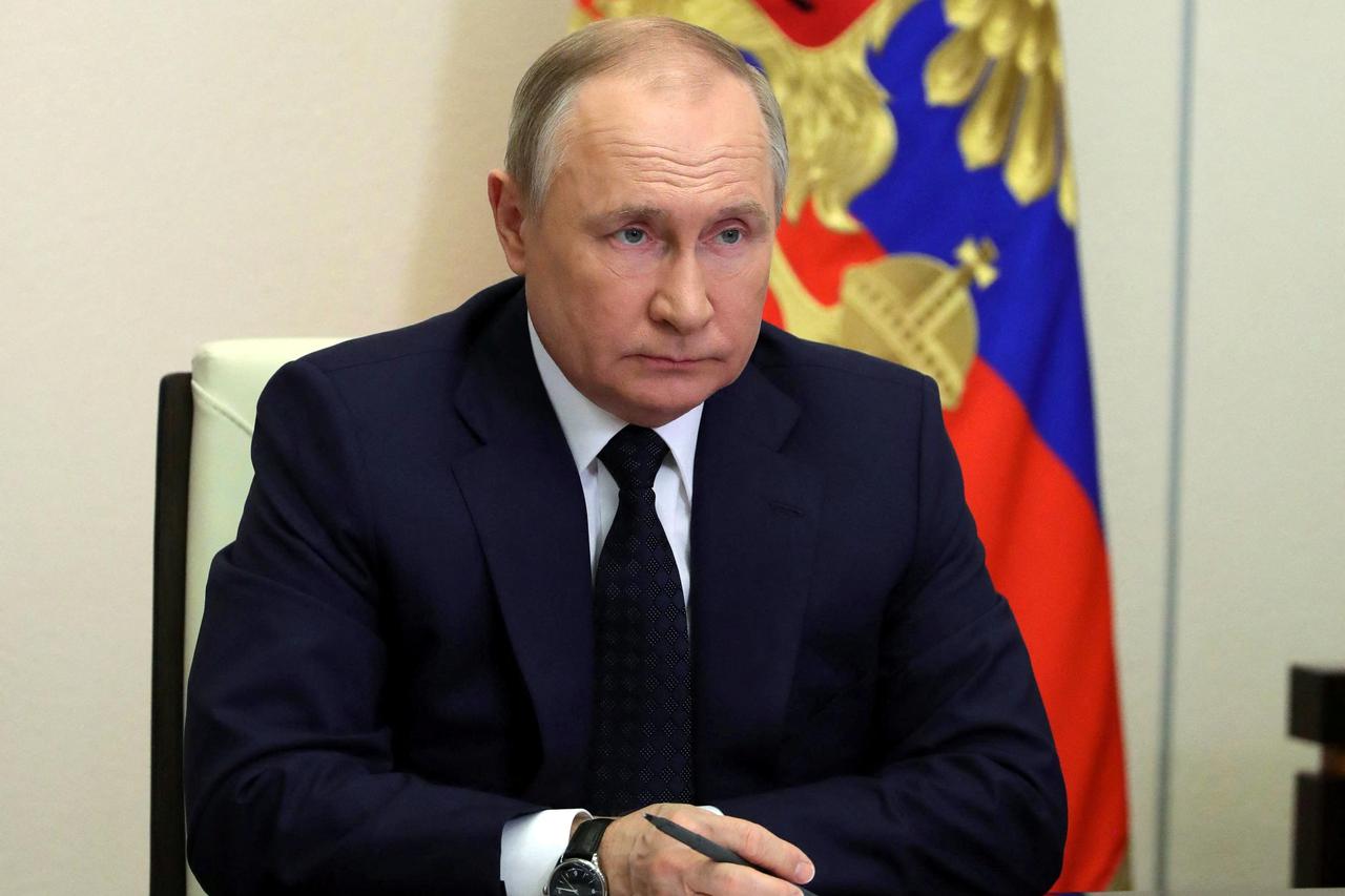 Russian President Vladimir Putin attends a meeting with government members via a video link at the state residence outside Moscow