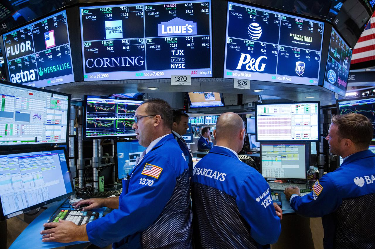 FILE PHOTO: Traders work on the floor of the New York Stock Exchange shortly before the closing bell in August 2015