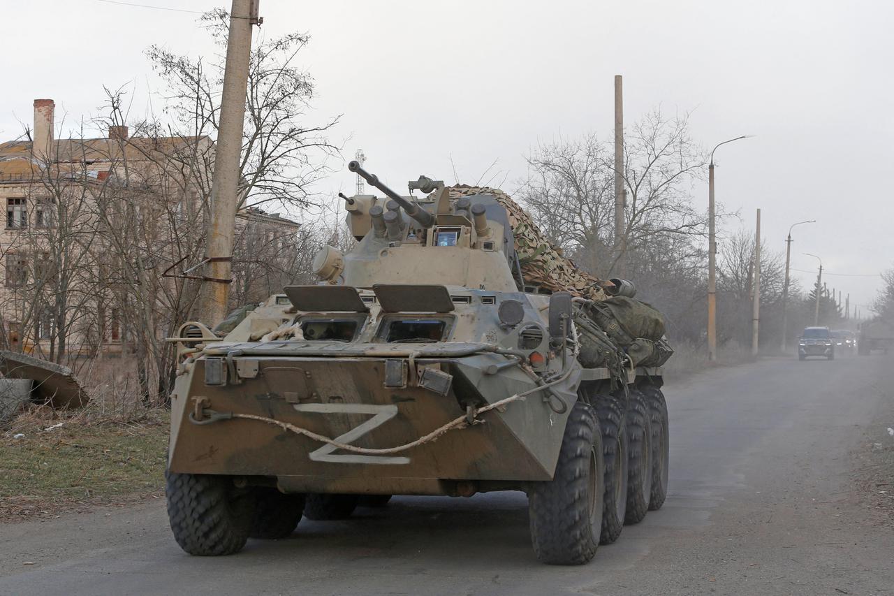 An armoured vehicle of pro-Russian troops drives along a road near the besieged city of Mariupol