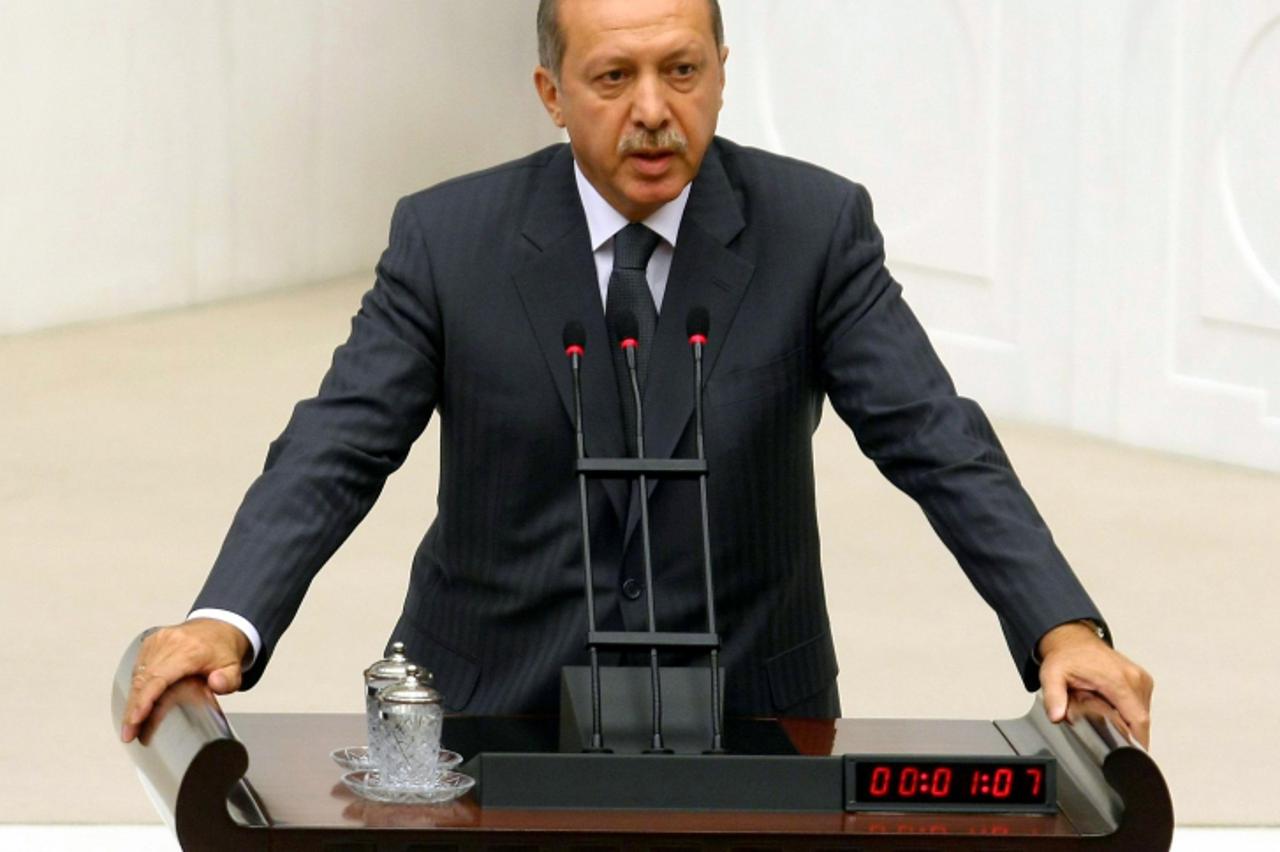 'Turkish Prime Minister Recep Tayyip Erdogan addresses lawmakers after his new government won a confidence vote in Ankara on July 13, 2011.    AFP PHOTO / ADEM ALTAN'