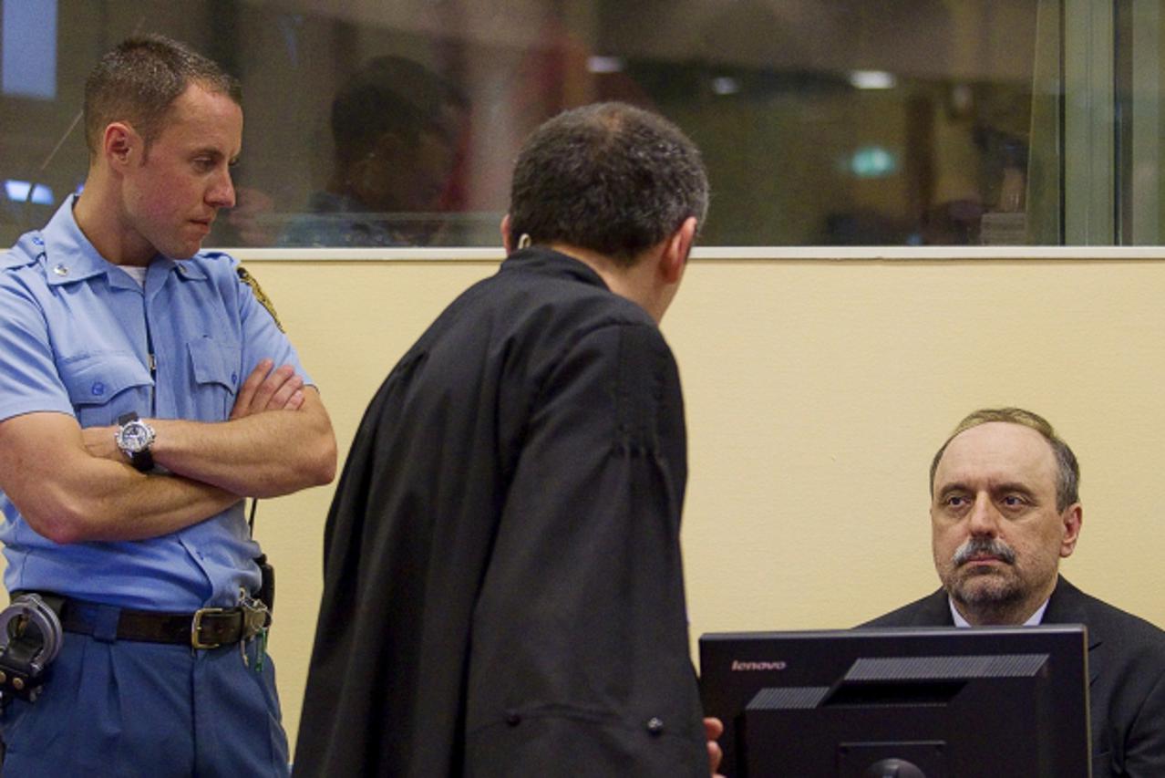 'Goran Hadzic (R), the last of Serbia's alleged war criminals, makes his initial appearance to stand trial on crimes against humanity at the International Criminal Tribunal for the former Yugoslavia 