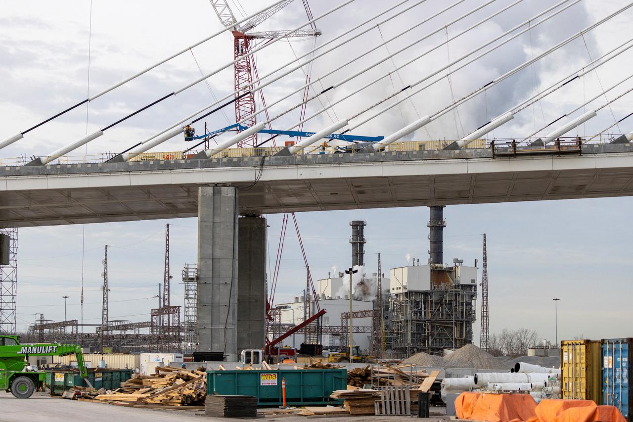 FILE PHOTO: A view of the still-under-construction Gordie Howe International Bridge and in the background Atura Power - Brighton Beach generating station, in Windsor