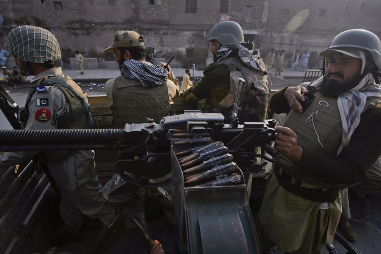 'Paramilitary forces patrol the streets of Peshawar, in northwest Pakistan November 26, 2011. NATO helicopters attacked a military checkpoint in northwest Pakistan on Saturday, killing up to 28 troops