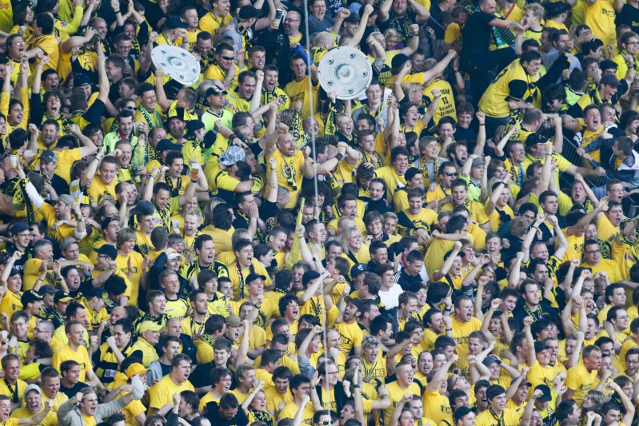 'Borussia Dortmund fans celebrate winning the German championships following their team\'s German Bundesliga first division soccer match against FC Nueremberg in Dortmund, April 30, 2011. Borussia Dor