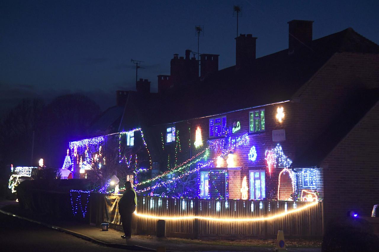 Visitors and locals view Christmas displays on dozens of properties that have been decorated in thousands of lights in a tradition that has grown over recent years in the small village of Westfield in Sussex, south east England, December 15, 2016. Picture