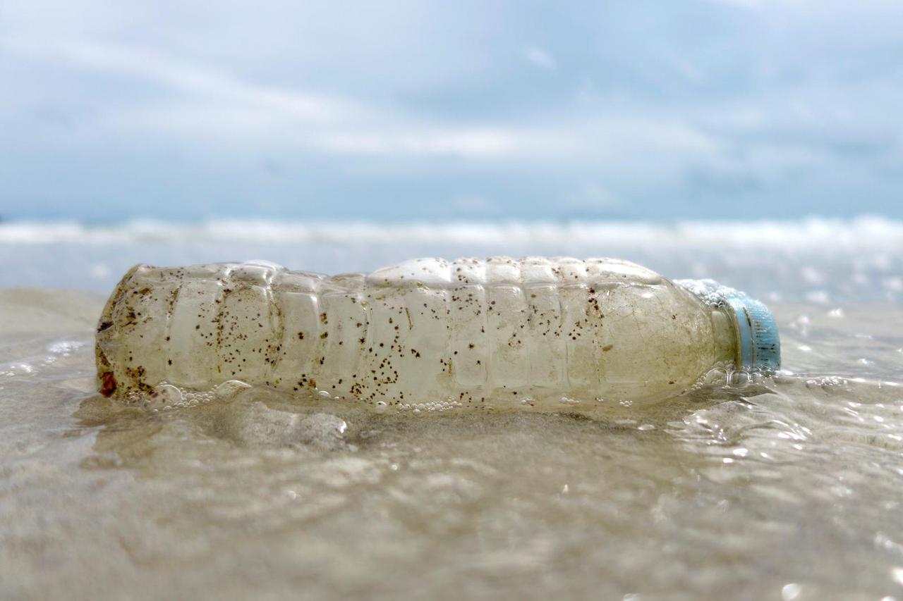 FILE PHOTO: A plastic bottle washed up by the sea is seen at the Ao Phrao Beach, on the island of Ko Samet