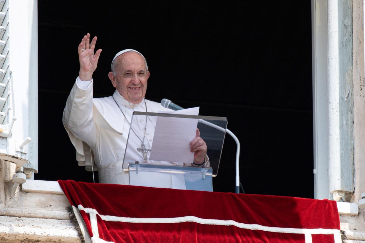 Pope Francis raises his hand in greeting as he delivers the Angelus hours before being admitted to Gemelli hospital for colon surgery, at the Vatican