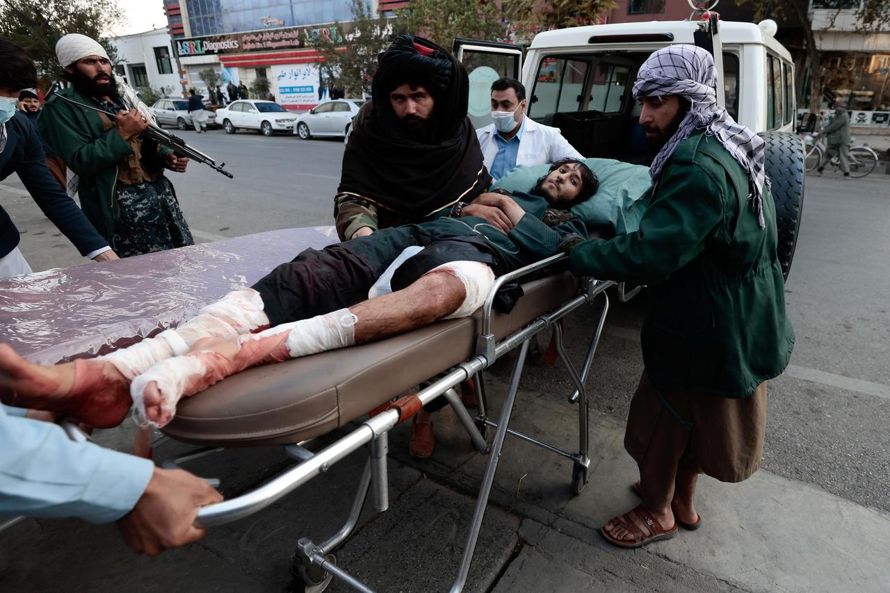Taliban fighter, injured during a blast, is pictured at the entrance of a hospital in Kabul