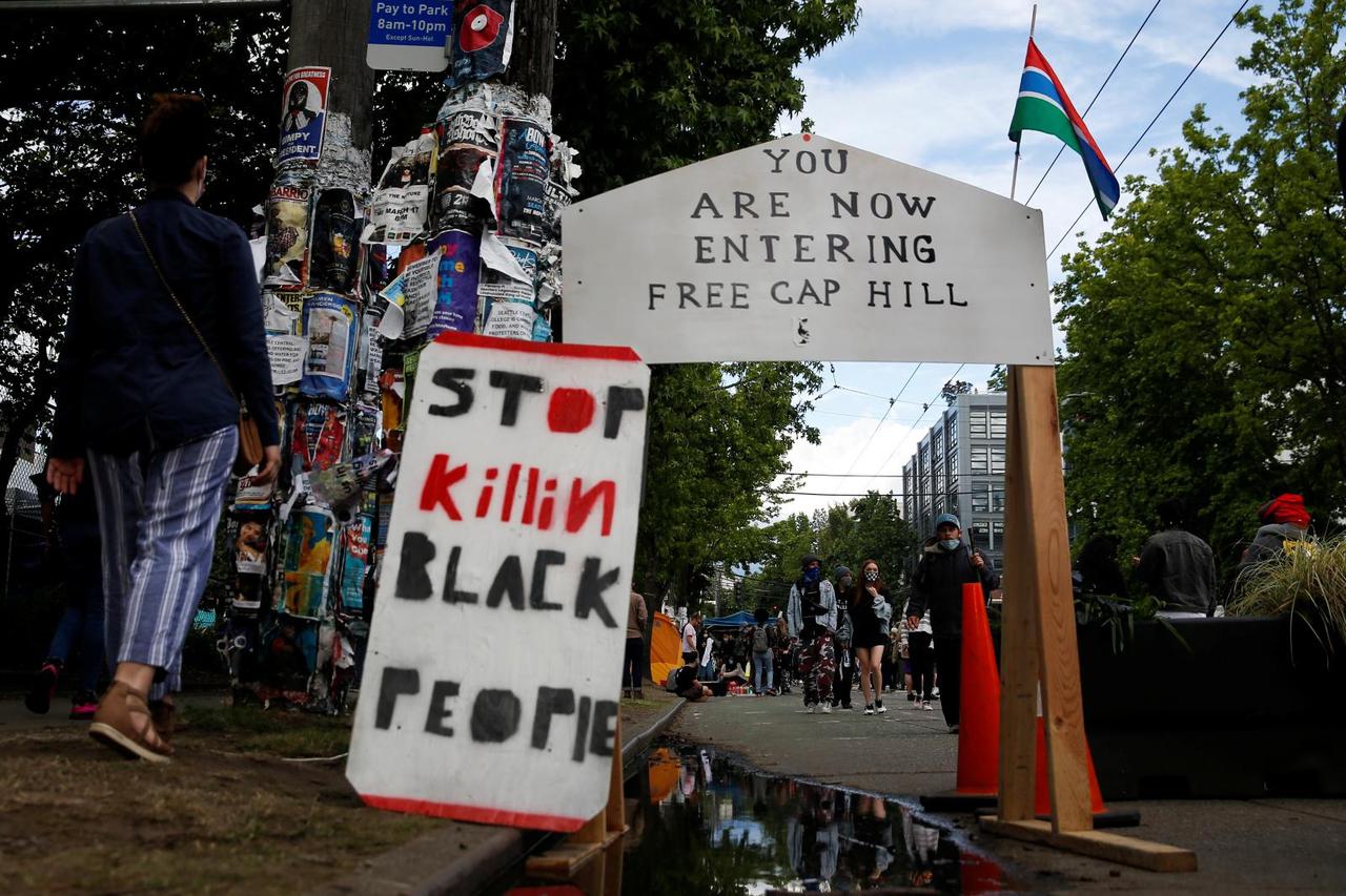 People protest at the CHAZ/CHOP zone around Seattle Police Department's East Precinct against racial inequality in the aftermath of the death in Minneapolis police custody of George Floyd, in Seattle