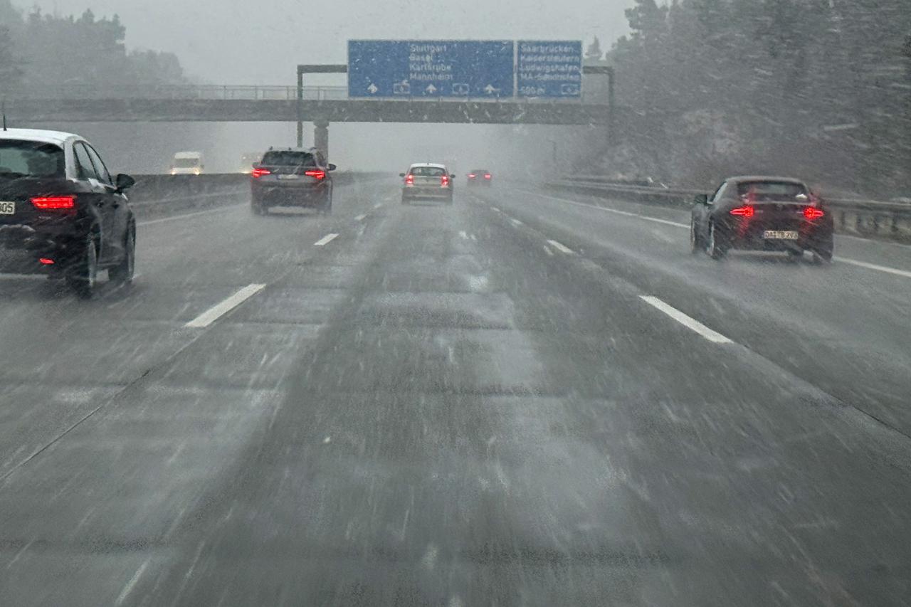 Vehicles make their way on the A6 Autobahn during heavy snowfall