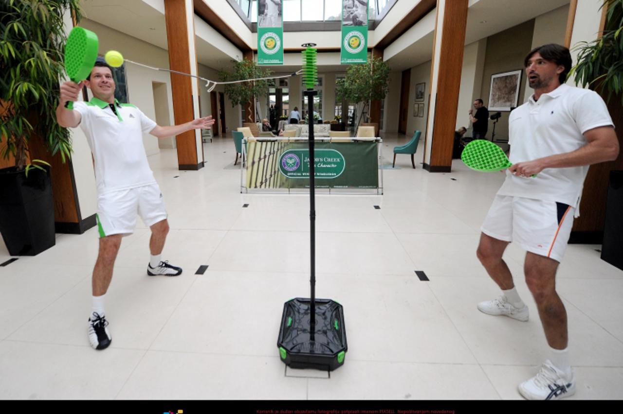 \'Tim Henman (left) and Goran Ivanisevic play swingball as they launch Swingballdon at the Hurlingham Club, London. PRESS ASSOCIATION Photo. Picture date: Thursday June 16, 2011. Photo credit should r