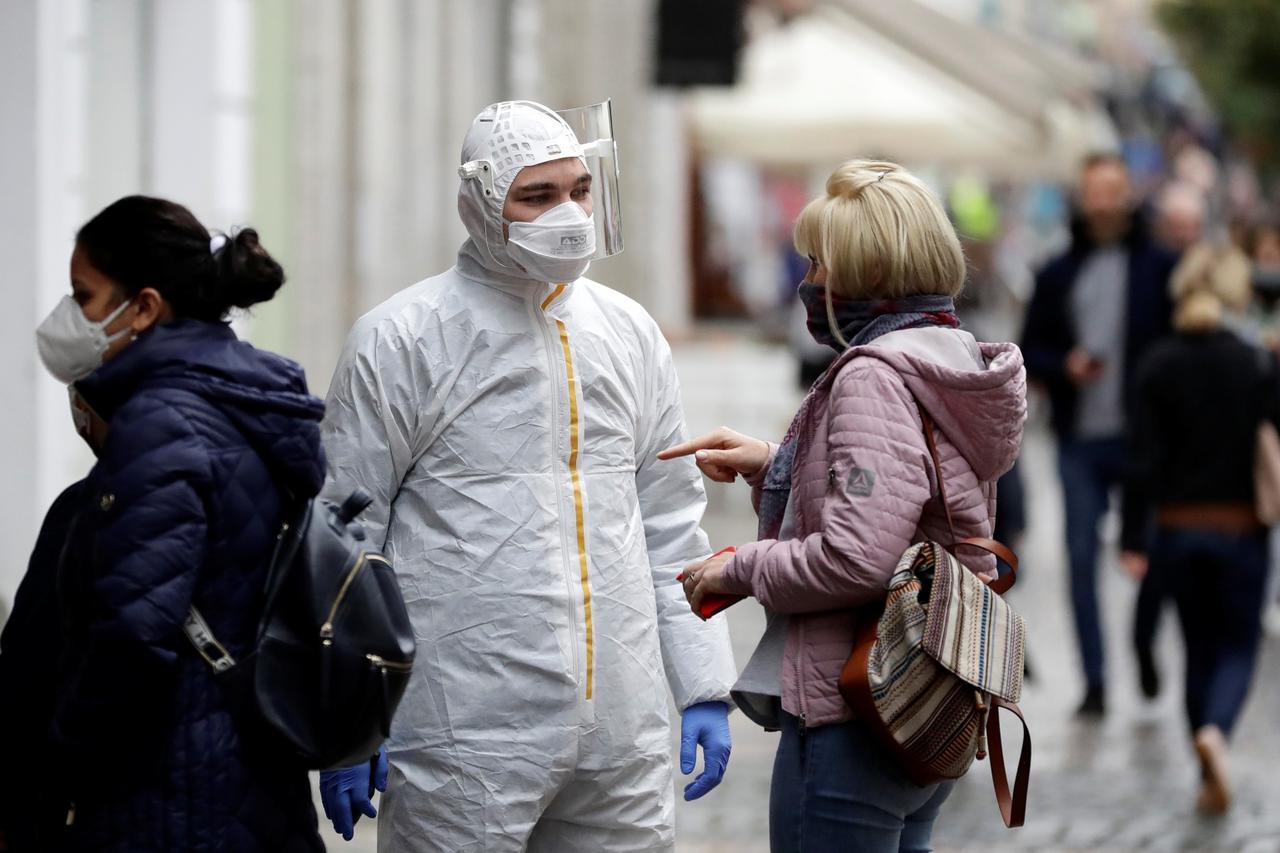 People wait to be tested for the coronavirus disease in Prague
