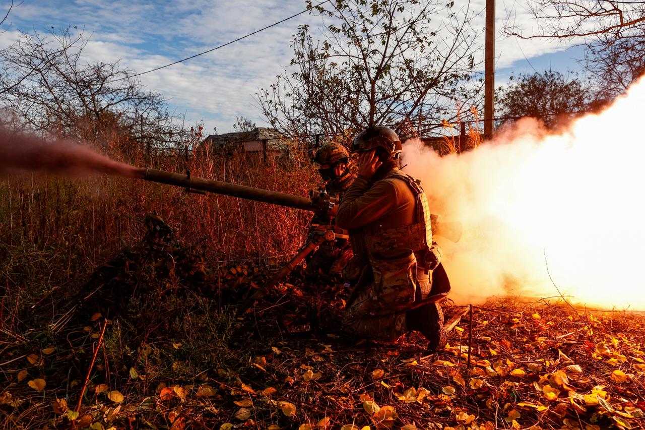 FILE PHOTO: Members of Ukraine's National Guard Omega Special Purpose fire a SPG-9 anti-tank grenade launcher toward Russian troops in the front line town of Avdiivka
