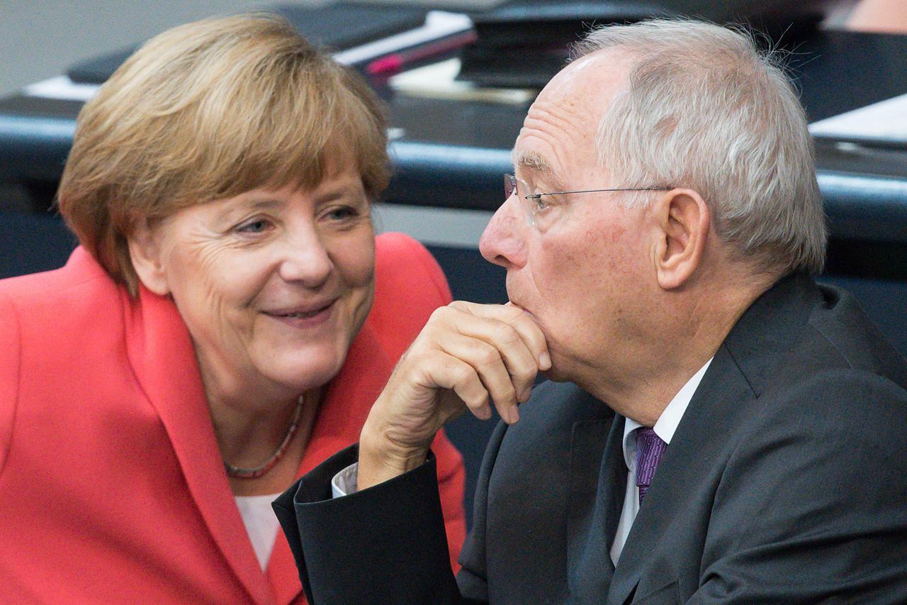 German Finance Minister Wolfgang Schaeuble (CDU, r) and German Chancellor Angela Merkel speak at special sitting of the German Bundestag where the German parliament over the proposed bailout package for Greece in Berlin, Germany, 17 July 2015.  The Bundes