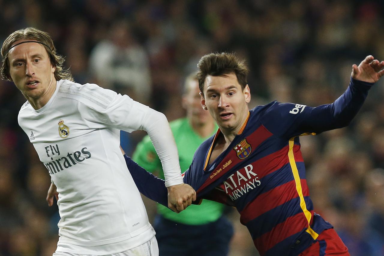 Football Soccer - FC Barcelona v Real Madrid - La Liga - Camp Nou, Barcelona - 2/4/16 Barcelona's Lionel Messi and Luis Suarez in action with Real Madrid's Luka Modric Reuters / Albert Gea Livepic EDITORIAL USE ONLY.