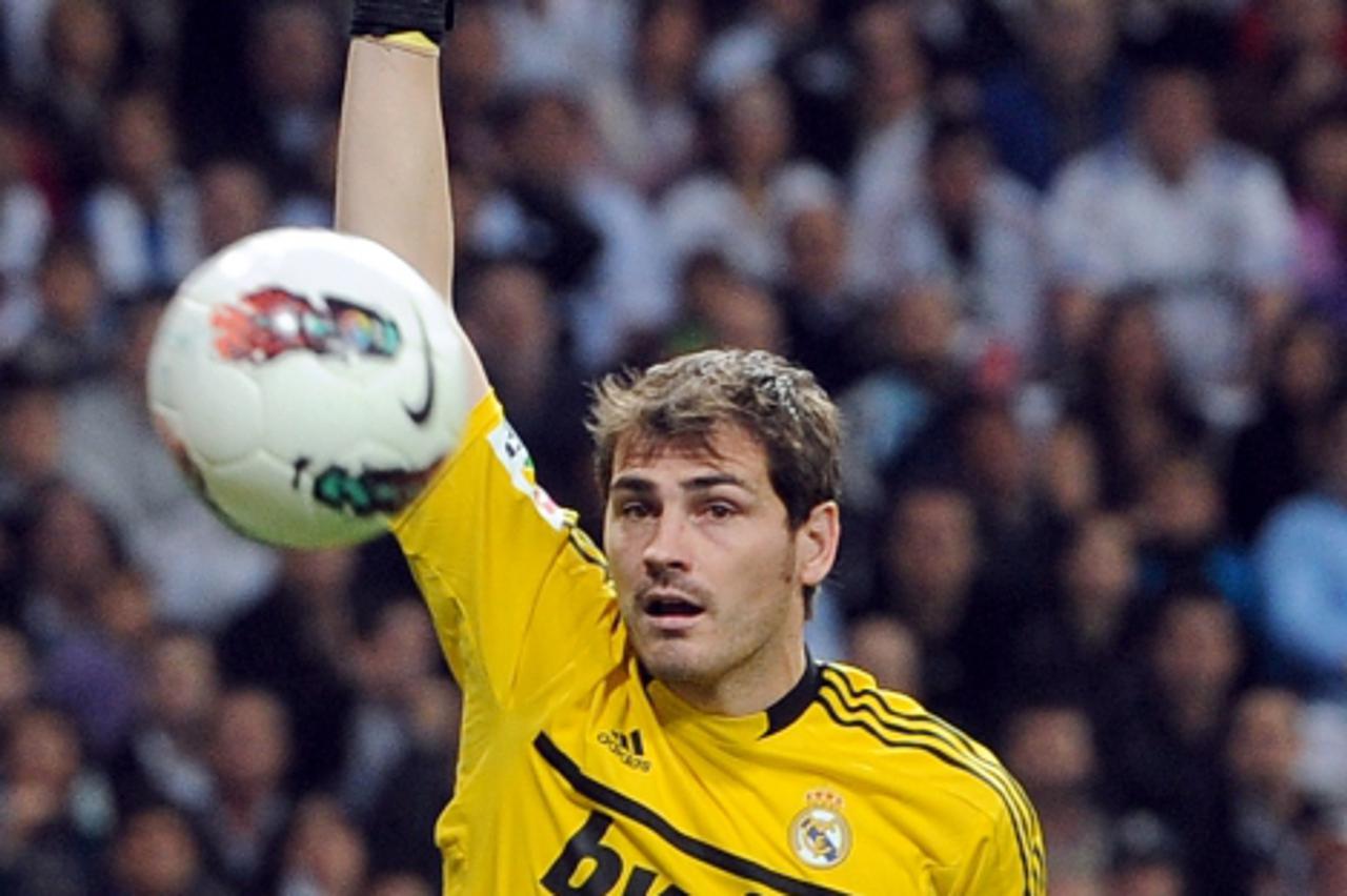 'Real Madrid\'s goalkeeper and captain Iker Casillas eyes the ball during the Spanish league football match Real Madrid against Valencia at the Santiago Bernabeu stadium in Madrid on April 8, 2012. Th
