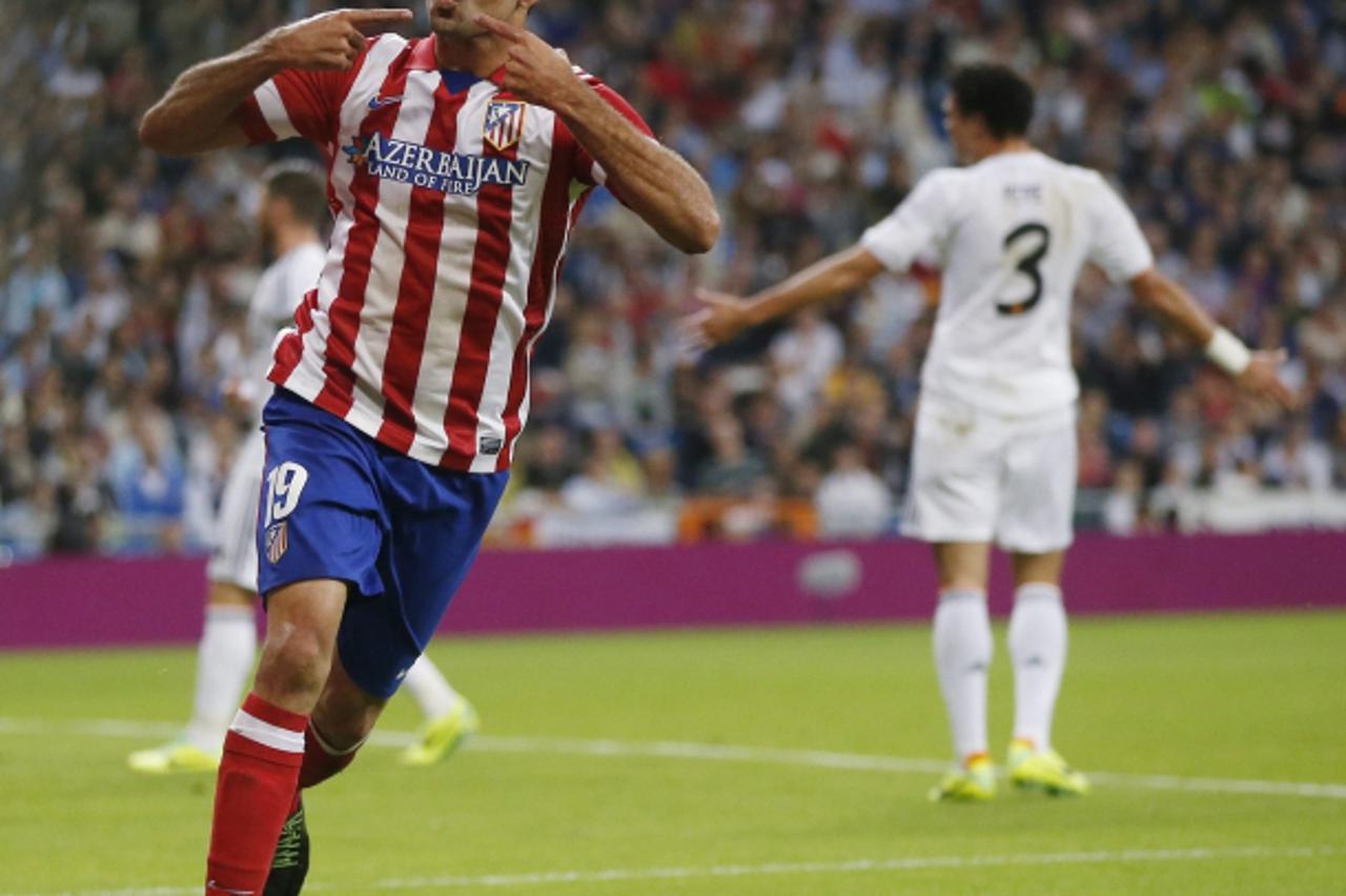 'Atletico Madrid\'s Diego Costa celebrates his goal during their Spanish first division soccer match against Real Madrid at Santiago Bernabeu stadium in Madrid September 28, 2013.    REUTERS/Juan Medi