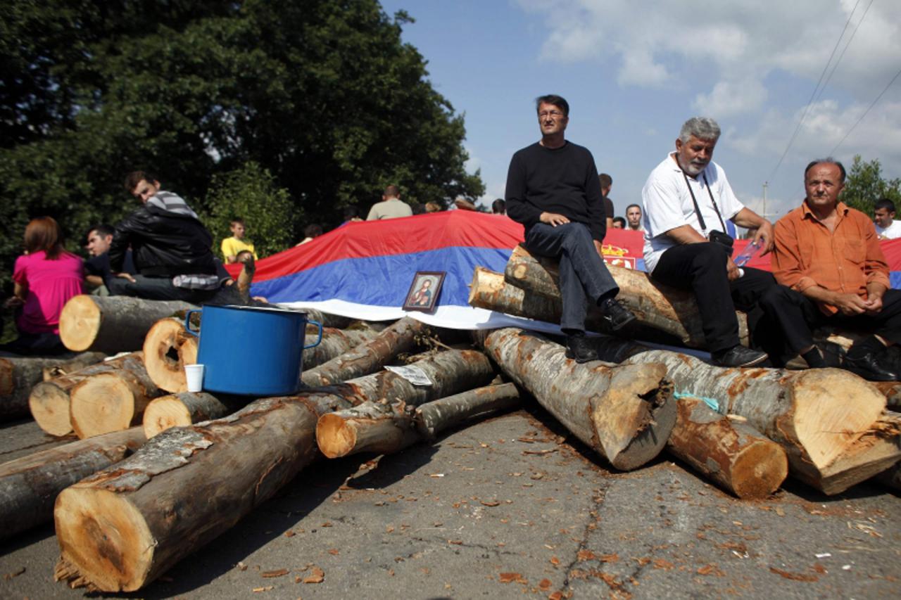 \'Kosovo Serbs sit on the barricades in the village of Zupce near the town of Zubin Potok August 1, 2011. Serbs vowed to press on with roadblocks and stop NATO\'s KFOR peacekeeping force from proceedi