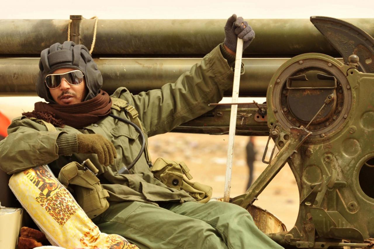 'A rebel fighter sits in a vehicle in Ajdabiyah April 7, 2011. Libya\'s civil war is reaching stalemate, a senior U.S. general said on Thursday, and rebels fighting to overthrow Muammar Gaddafi said a