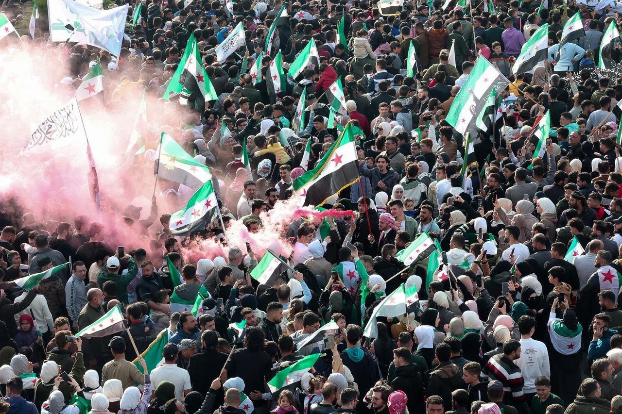 Residents of Hama demonstrate to mark the first anniversary of the fall of the Bashar al-Assad's regime