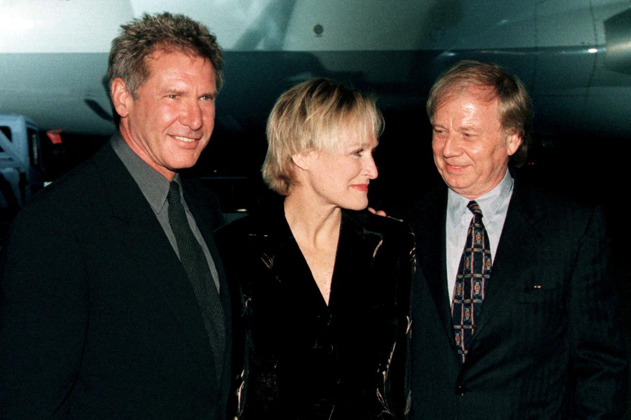 FILE PHOTO: Actors Harrison Ford and Glenn Close and German director Wolfgang Petersen smile after their arrival in Munich