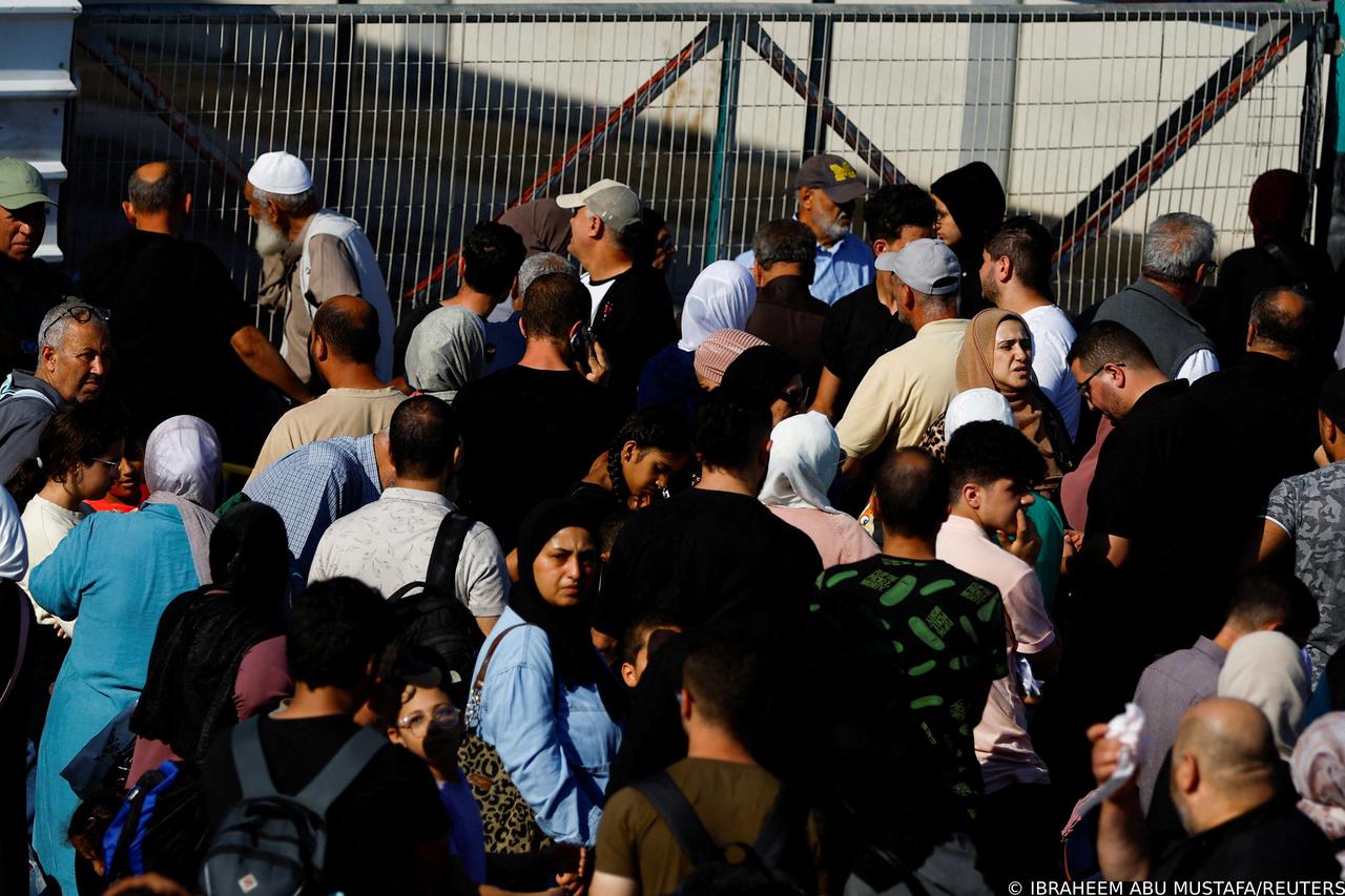 Palestinians with dual citizenship gather outside Rafah border crossing with Egypt