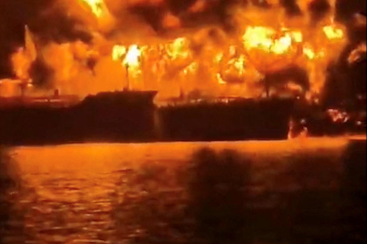 A ship burns, after Iranian explosive-laden boats appear to have attacked two fuel tankers in Iraqi waters setting them ablaze